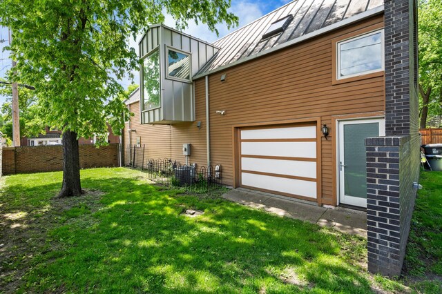 818 Summit Ave, Saint Paul, MN 55105 - view of side of home featuring a standing seam roof, metal roof, and central AC unit