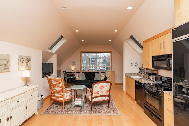 818 Summit Ave, Saint Paul, MN 55105 - kitchen with black appliances, light wood-style flooring, lofted ceiling, a sink, and light stone counters