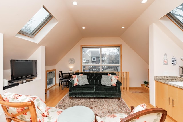 818 Summit Ave, Saint Paul, MN 55105 - living area featuring a skylight, light wood-style floors, heating unit, vaulted ceiling, and recessed lighting