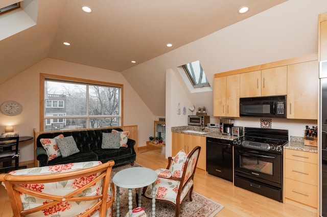 818 Summit Ave, Saint Paul, MN 55105 - kitchen with black appliances, light brown cabinets, a skylight, light wood finished floors, and light stone countertops
