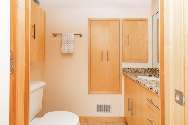 818 Summit Ave, Saint Paul, MN 55105 - bathroom with toilet, vanity, and tile patterned flooring