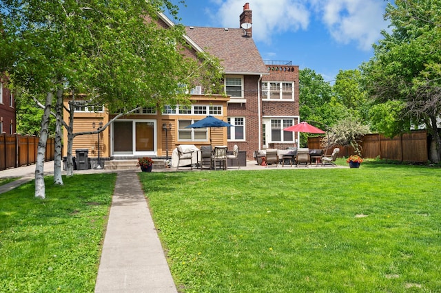 818 Summit Ave, Saint Paul, MN 55105 - back of property featuring an outdoor living space, entry steps, a patio, a chimney, and brick siding