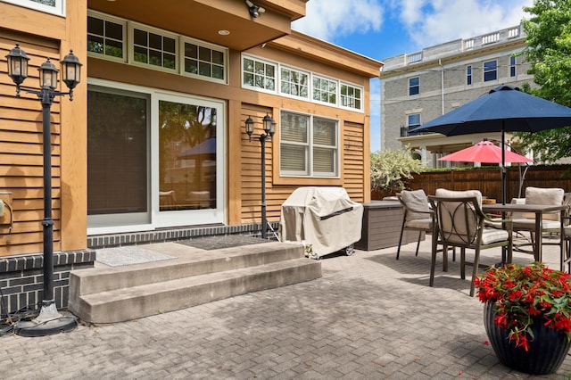 818 Summit Ave, Saint Paul, MN 55105 - view of patio with area for grilling, outdoor dining area, and fence