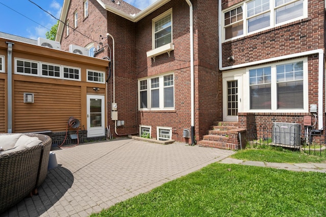 818 Summit Ave, Saint Paul, MN 55105 - back of property featuring entry steps, brick siding, and a patio area