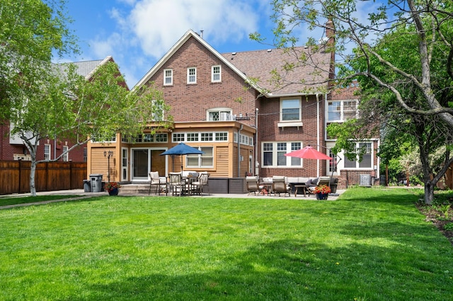 818 Summit Ave, Saint Paul, MN 55105 - rear view of property with outdoor lounge area, brick siding, a chimney, a patio, and central AC