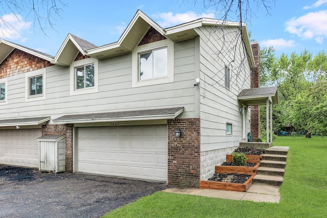 7527 102nd St, Bloomington, MN 55438 - view of side of home featuring an attached garage, a yard, and brick siding