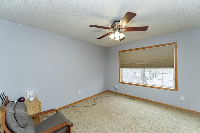 unfurnished room with a ceiling fan, carpet flooring, visible vents, and baseboards