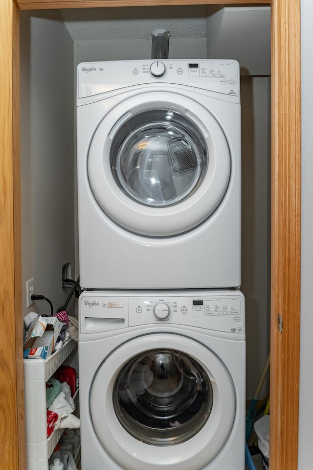 laundry area featuring stacked washer / drying machine