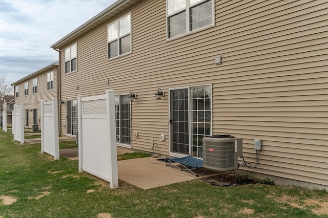 back of property featuring a patio, central AC unit, and a yard