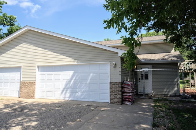 14190 Pineview Dr, Becker, MN 55308 - view of front facade with brick siding, a garage, and roof with shingles