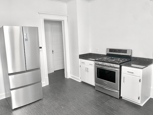 1605 Dupont Ave N, Minneapolis, MN 55411 - kitchen with baseboards, appliances with stainless steel finishes, and white cabinetry
