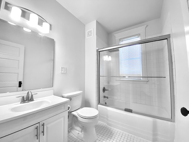 1605 Dupont Ave N, Minneapolis, MN 55411 - bathroom featuring combined bath / shower with glass door, tile patterned floors, vanity, and toilet