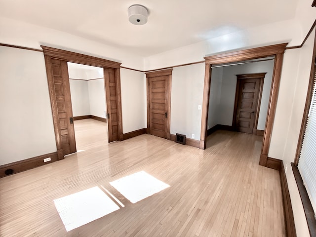 1605 Dupont Ave N, Minneapolis, MN 55411 - unfurnished bedroom featuring baseboards, light wood-style floors, and visible vents