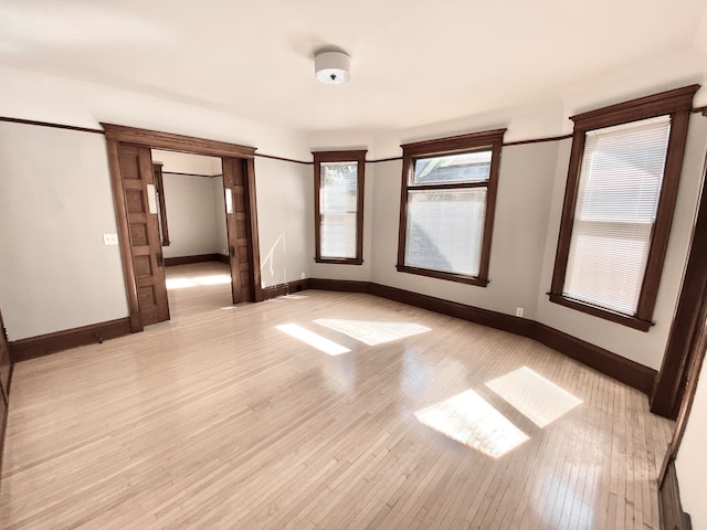 1605 Dupont Ave N, Minneapolis, MN 55411 - spare room featuring light wood-type flooring and baseboards