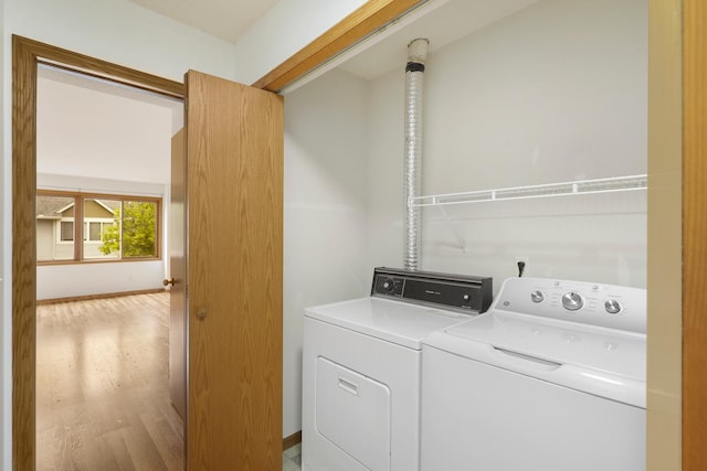 8722 Norway St NW, Coon Rapids, MN 55433 - washroom featuring independent washer and dryer, light wood-type flooring, and baseboards