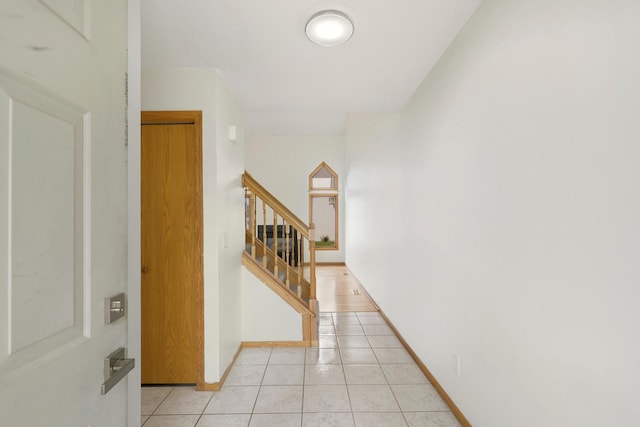 8722 Norway St NW, Coon Rapids, MN 55433 - entryway with stairs, light tile patterned floors, and baseboards