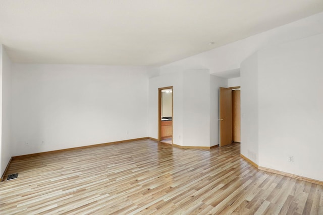 8722 Norway St NW, Coon Rapids, MN 55433 - spare room featuring light wood-style floors and baseboards