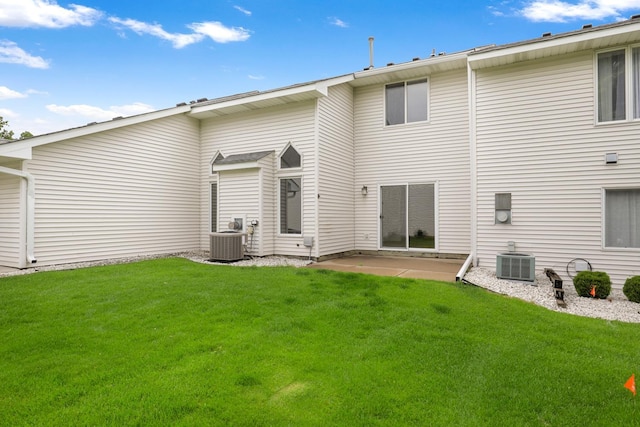 8722 Norway St NW, Coon Rapids, MN 55433 - rear view of property with central air condition unit, a lawn, and a patio
