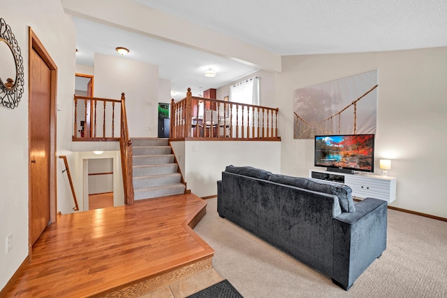 carpeted living room featuring stairway, lofted ceiling with beams, and baseboards