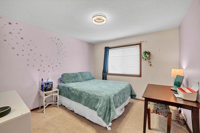 bedroom with a textured ceiling and light carpet