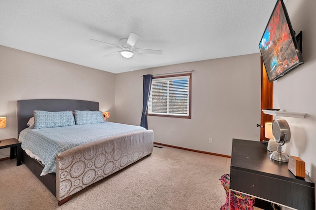 carpeted bedroom featuring baseboards, a ceiling fan, and a textured ceiling