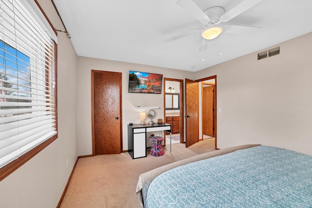 bedroom with baseboards, visible vents, multiple windows, and light colored carpet