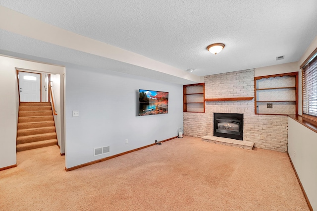 unfurnished living room with baseboards, visible vents, a textured ceiling, and carpet flooring
