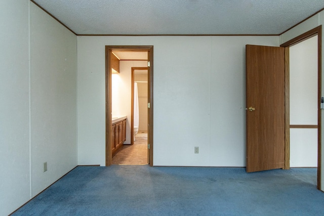 unfurnished bedroom with light colored carpet, ornamental molding, and a textured ceiling
