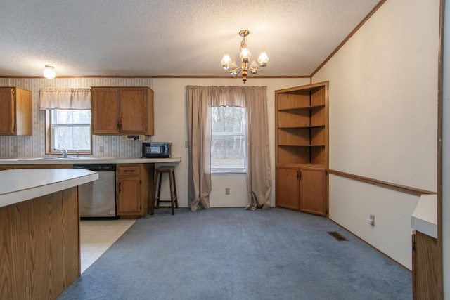 kitchen featuring light countertops, dishwasher, black microwave, a textured ceiling, and a notable chandelier