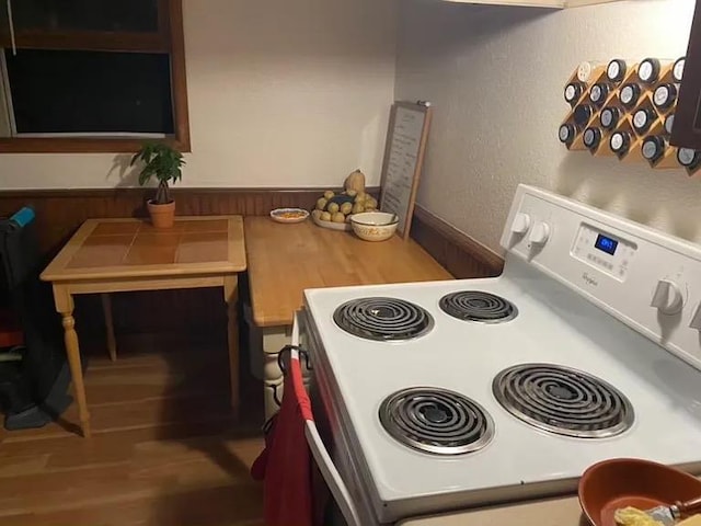 408 Lyon Ave, Lake City, MN 55041 - kitchen with white electric range oven, a textured wall, and wood finished floors