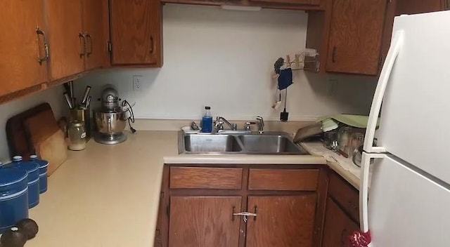 408 Lyon Ave, Lake City, MN 55041 - kitchen with brown cabinets, a sink, light countertops, and freestanding refrigerator