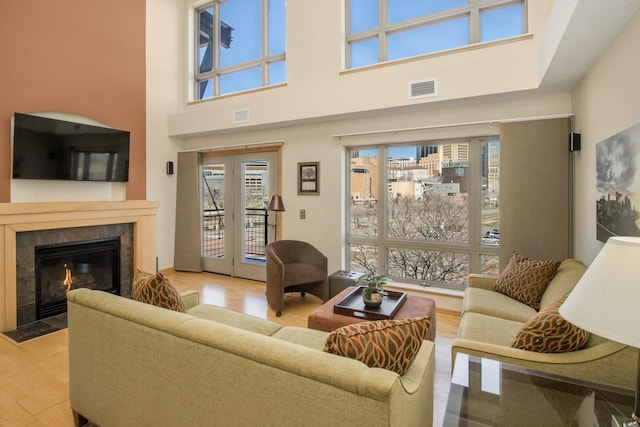 240 Spring St Unit 331, Saint Paul, MN 55102 - living room featuring a high ceiling, wood finished floors, a fireplace, and visible vents