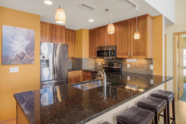 240 Spring St Unit 331, Saint Paul, MN 55102 - kitchen featuring tasteful backsplash, visible vents, a sink, a peninsula, and stainless steel appliances