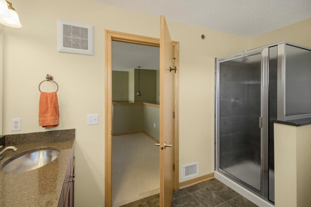 240 Spring St Unit 331, Saint Paul, MN 55102 - full bathroom featuring vanity, visible vents, baseboards, and a stall shower