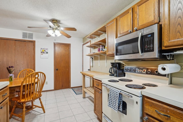 kitchen featuring open shelves, white range with electric cooktop, stainless steel microwave, and brown cabinetry