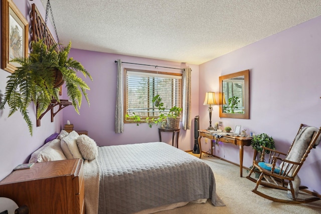 bedroom with carpet floors and a textured ceiling