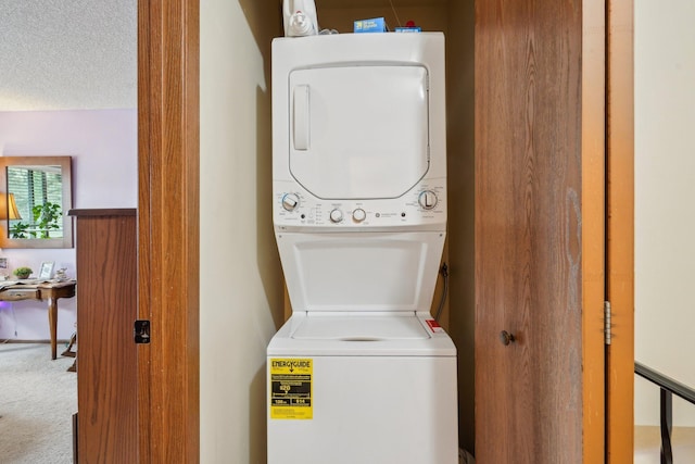 laundry room with laundry area, carpet flooring, and stacked washer / dryer