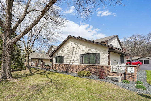 view of property exterior with a yard and brick siding