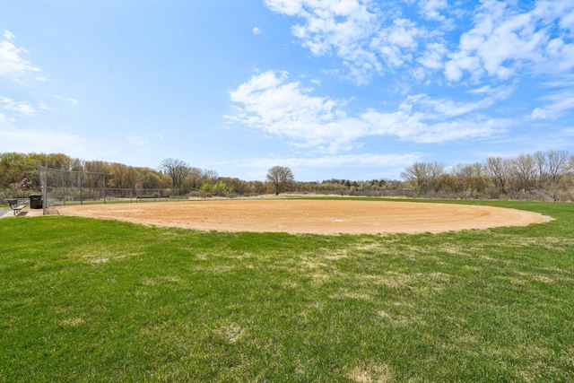 surrounding community with a yard and fence