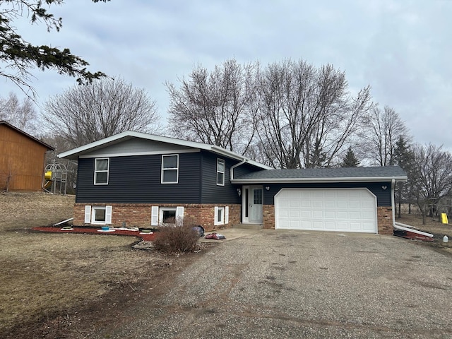 split level home with driveway and a garage