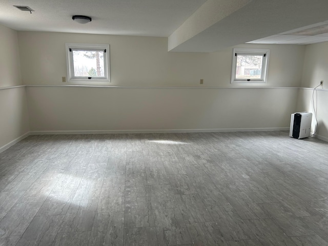 interior space with plenty of natural light, visible vents, and wood finished floors
