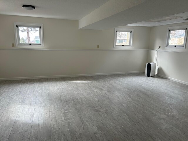 below grade area with wood finished floors and a wealth of natural light