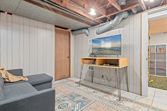 finished below grade area with wooden walls and tile patterned flooring