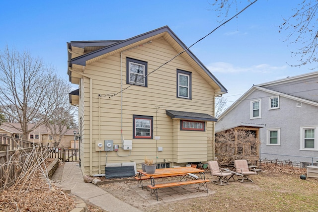 rear view of house featuring fence and a patio area