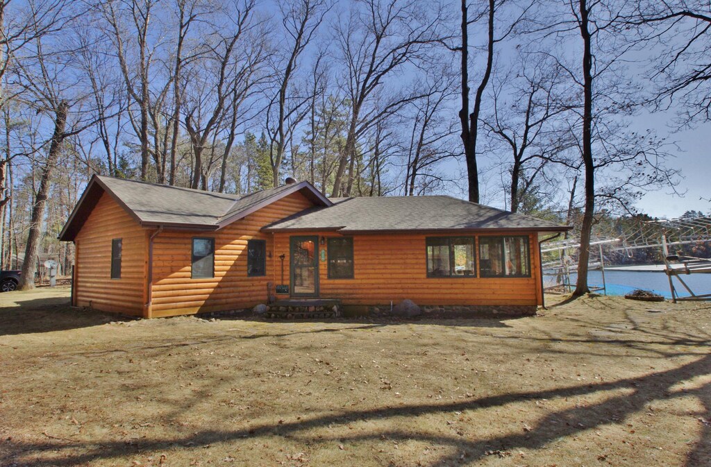 10398 Sandy Beach Rd, Hayward, WI 54843 - chalet / cabin with roof with shingles and log veneer siding