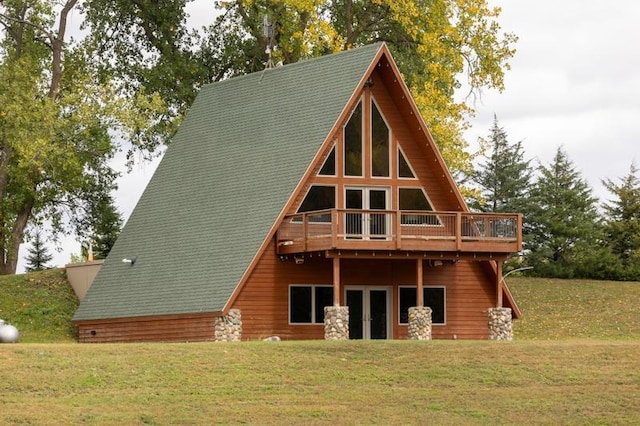 back of house featuring a wooden deck and a lawn