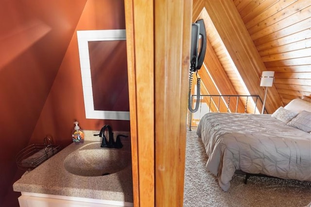 bedroom featuring carpet flooring, wood ceiling, a sink, and lofted ceiling