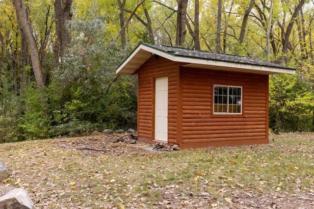 view of shed with a wooded view