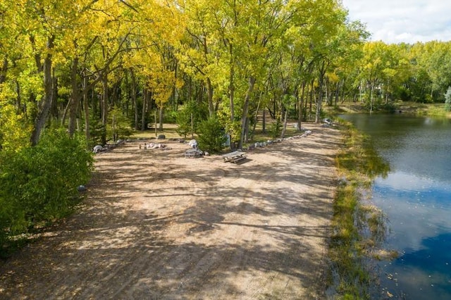 surrounding community featuring a wooded view and a water view