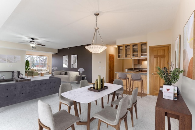 dining area featuring a ceiling fan and light colored carpet